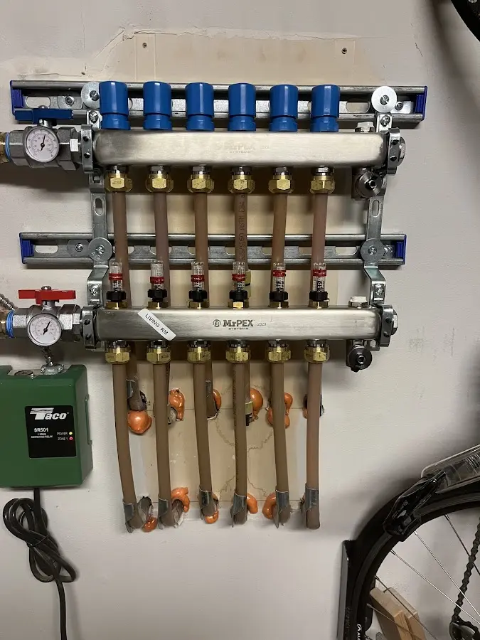 Plumber performing Water Heater Repair at a residential property in Champlin